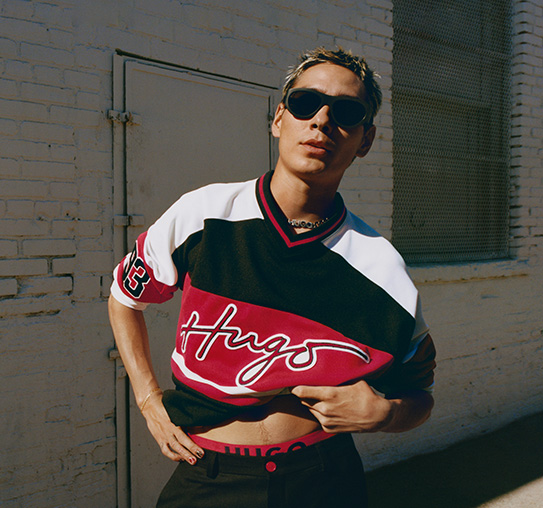 Evan Mock in sports-style shirt and black pants (Photo)