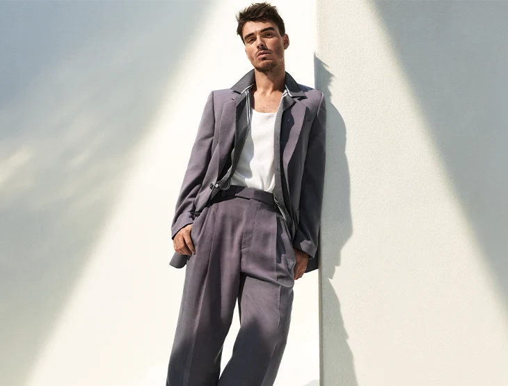 Portrait of Corey Mylchreest in mauve suit (photo)